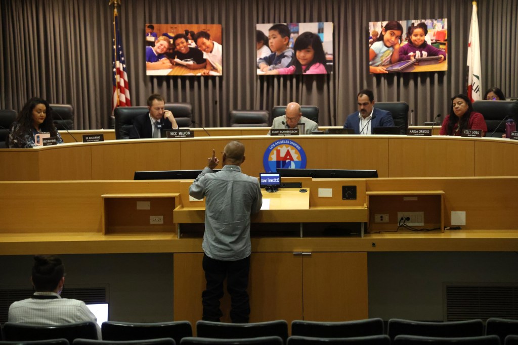 Los Angeles Board of Education members listen to a parent speak during public comments at the LAUSD Headquarters.