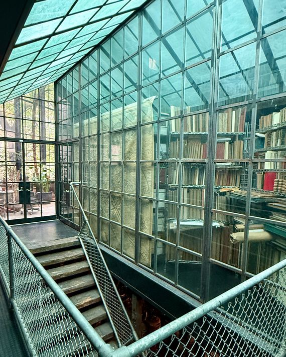Middleton’s library is enclosed in a grid of glass that extends across the entrance to the solarium in back.