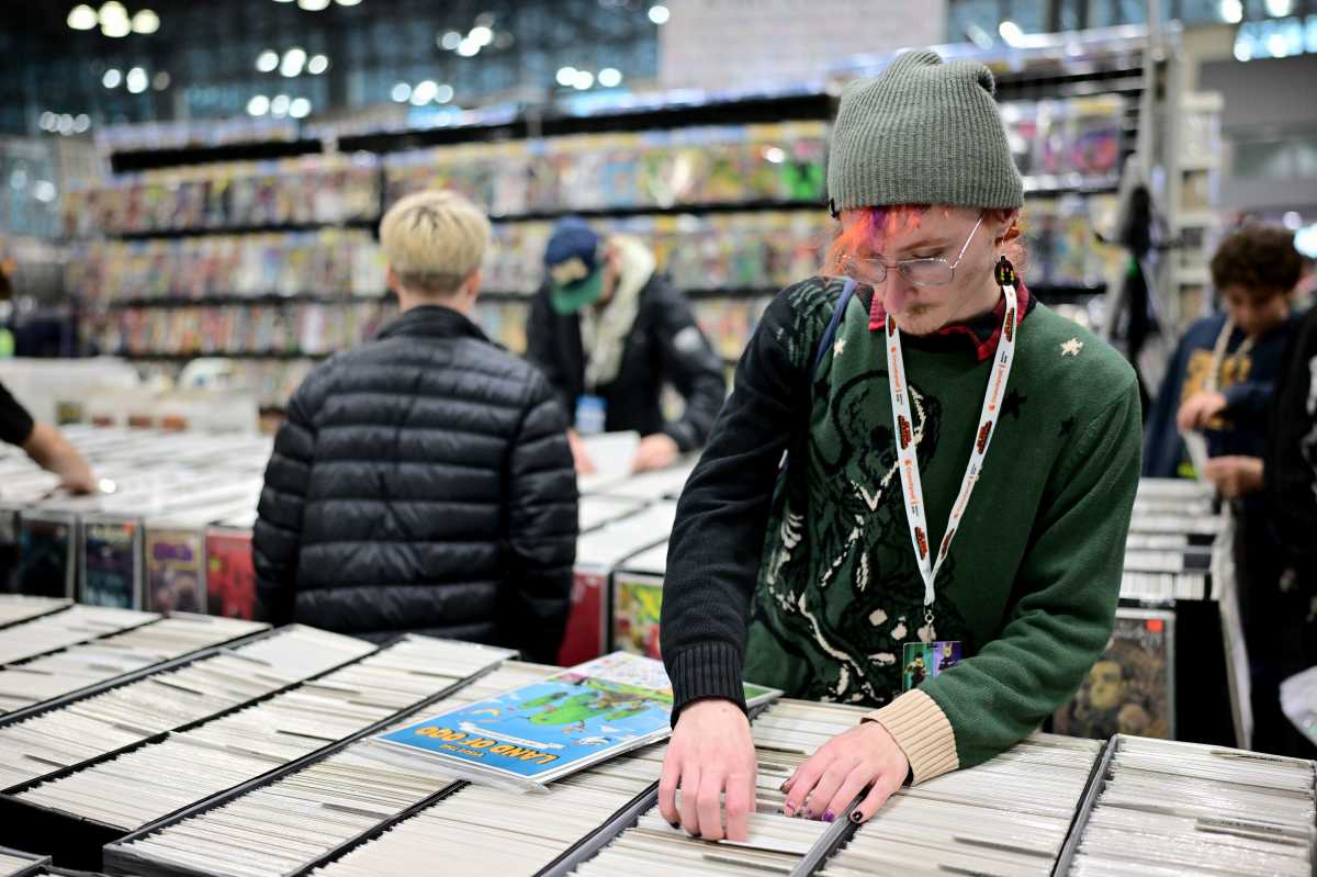 Fans browse comics during New York Comic Con 2025 at The Jacob K. Javits Convention Center on October 12, 2025 in New York City. 