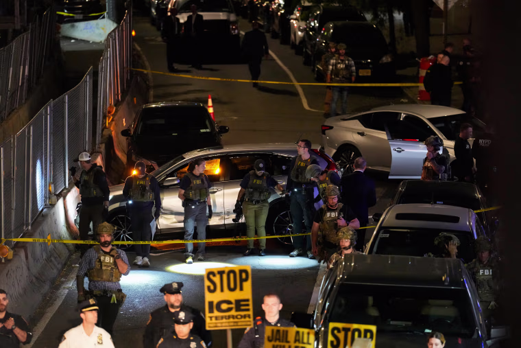 FBI agents gather around a scene.