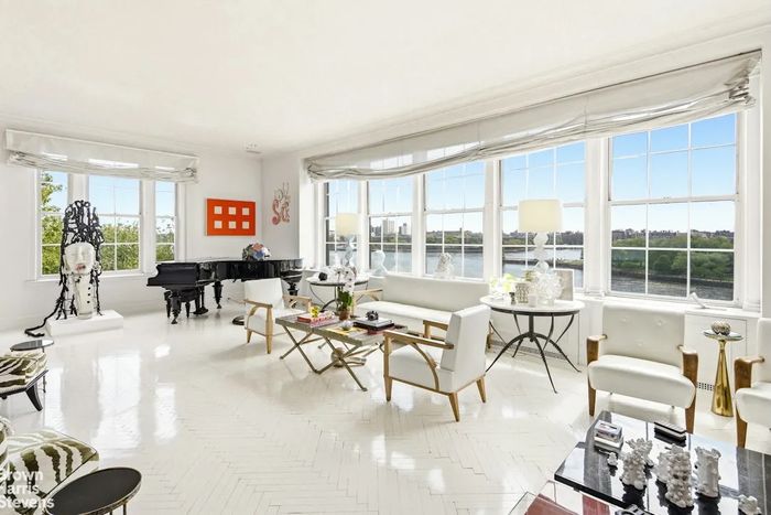 A listing shows a 32-foot-long living room stuffed with art and backed by views of the river.