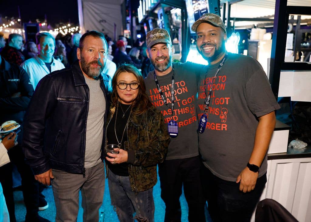 Rachael wears a statement jacket as she poses with Bert Kreischer and Jeremy Robinson-Leon at the Blue Moon Burger Bash 