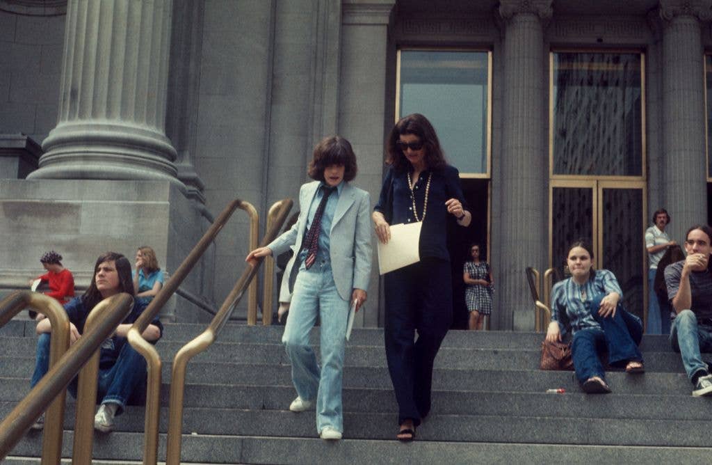 Jacqueline Kennedy Onassis with John F Kennedy; Jr. leaving the Metropolitan Museum of Art; circa 1970; New York