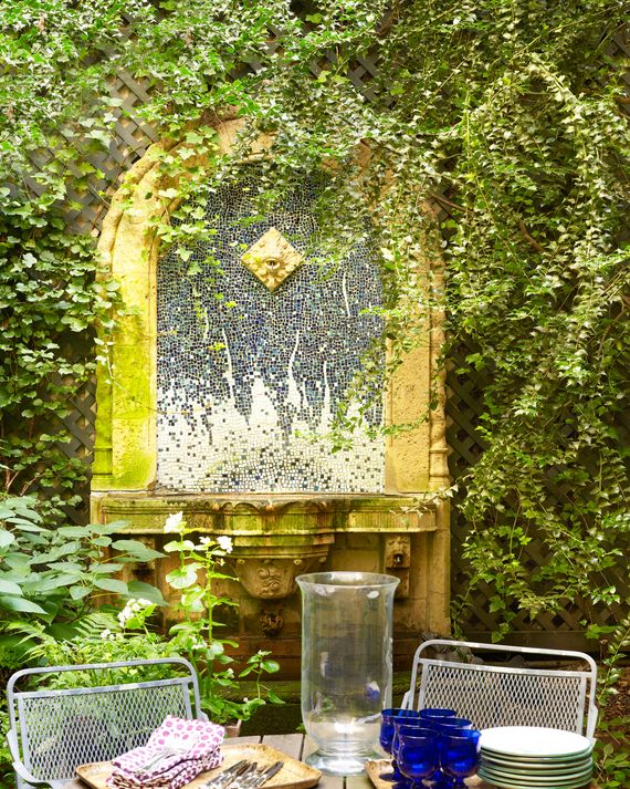 A burbling backyard fountain with a mosaic backsplash.
