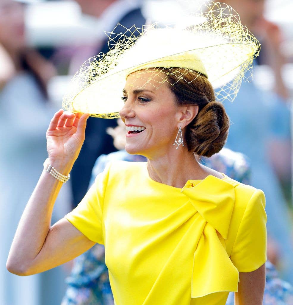 Princess Kate wearing a matching yellow dress and fascinator