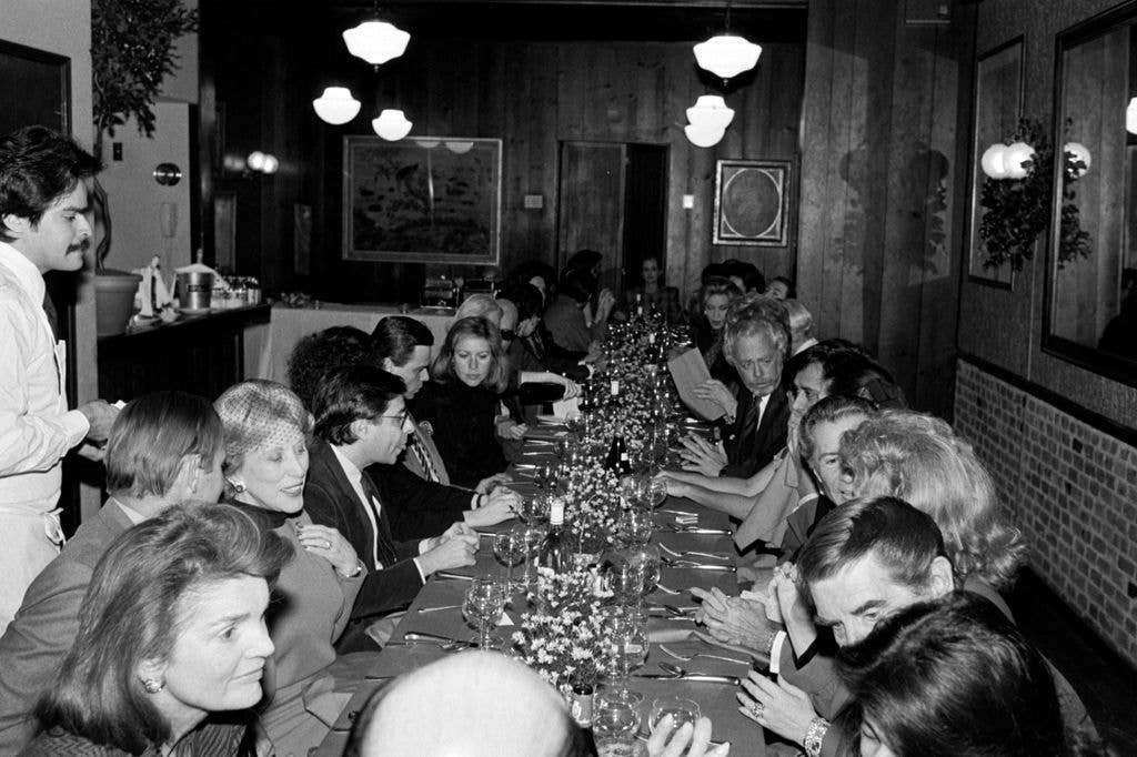 Guests including Jacqueline Bouvier Kennedy Onassis and Estee Lauder attend a party at Mortimer's, a restaurant in New York City, on December 10, 1985
