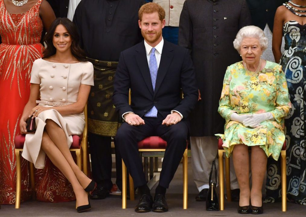 Meghan Markle, Prince Harry and Queen Elizabeth sitting side-by-side.