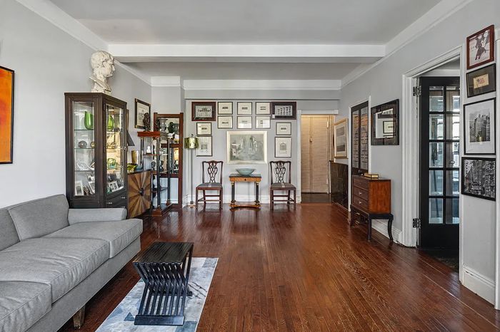 As seen in this listing photo, the many prewar details in this Upper West Side apartment complement what amounts to a personal museum in the living room.