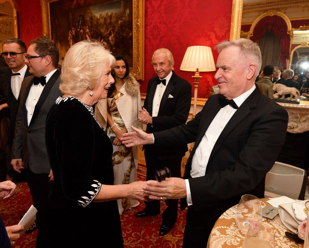 Queen Camilla is greeted by Lord Jeffrey Archer at the Julien Macdonald Fashion Show Reception in 2018