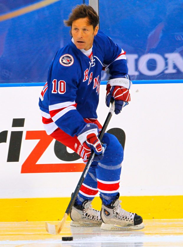 Ron Duguay of the New York Rangers Alumni team moves the puck during the Winter Classic Alumni hockey game with the Philadelphia Flyers Alumni team, Saturday, Dec. 31, 2011 in Philadelphia.