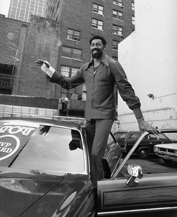 Wilt "The Stilt" Chamberlain, star center for the NBA champion Los Angeles Lakers, gets set to try out the car he won as most valuable player in the playoff series against the New York Knicks in a parking lot near a New York City restaurant on May 11, 1972. (AP Photo)