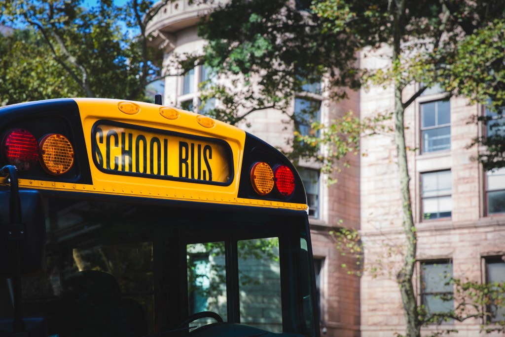 Close up of the front sign and lights of an American yellow school bus.