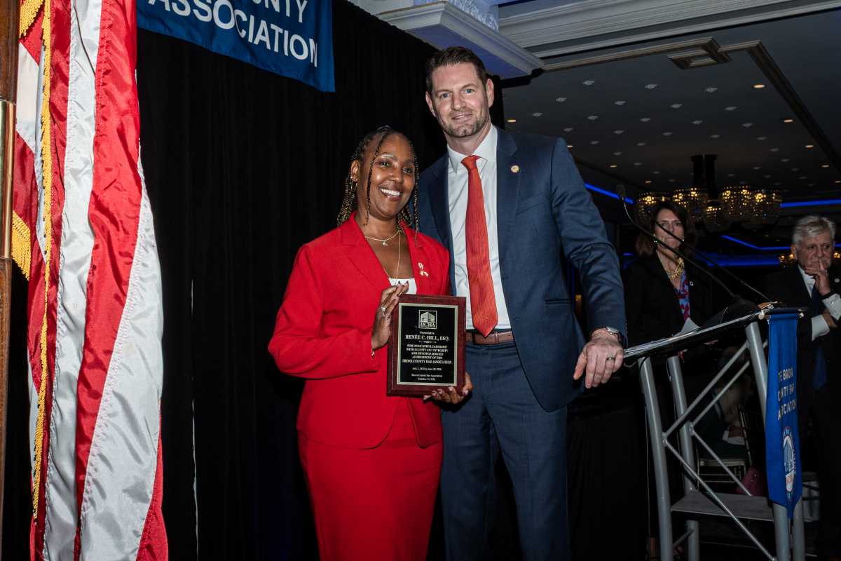 Chairperson of the Bronx County Bar Association Board, Renee C. Hill, poses with her BCBA award alongside the newly installed President of the Bronx County Bar Association, Nicolas Bagley.
