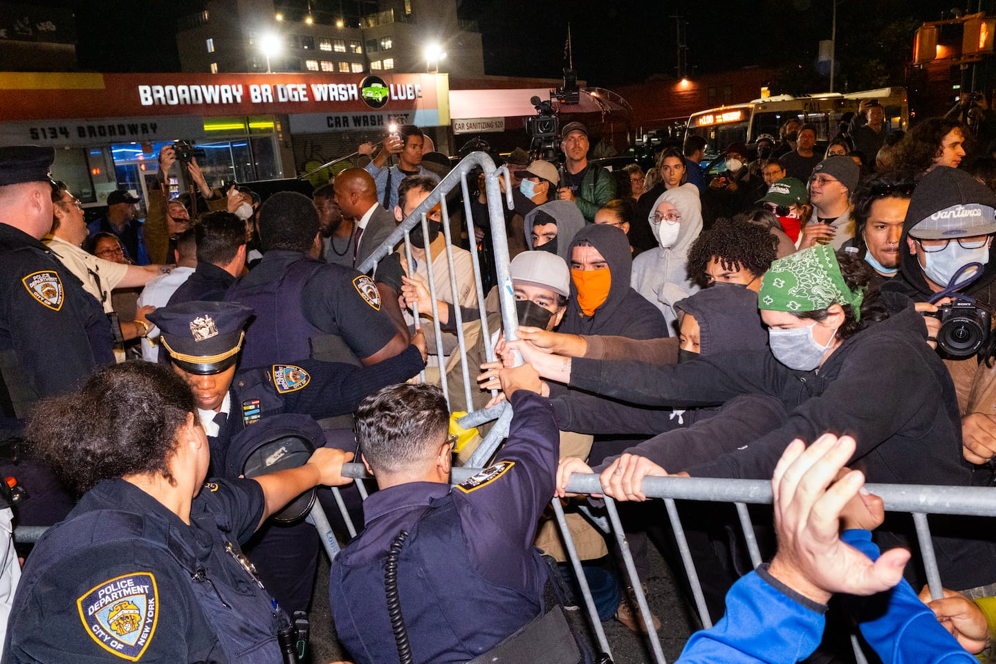 Protesters clashed with police near the scene where a federal immigration agent shot a man in the Marble Hill neighborhood of New York.