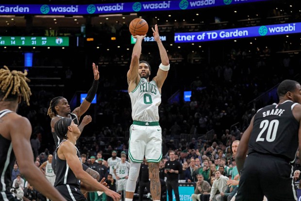 Boston Celtics star Jayson Tatum shoots his game-winning shot in overtime to sink the Nets. Stuart Cahill/Boston Herald