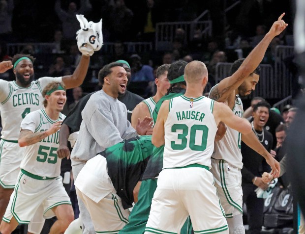 Boston Celtics star Jayson Tatum celebrates his game-winning shot in overtime with his teammates after a win over the Nets. Stuart Cahill/Boston Herald