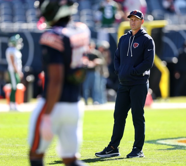 Chicago Bears head coach Ben Johnson stands on the field as players warm up for a game between the Bears and the New York Jets at Soldier Field in Chicago on Oct. 4, 2026. (Chris Sweda/Chicago Tribune)