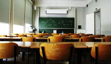 A large, empty classroom, lit by morning light
