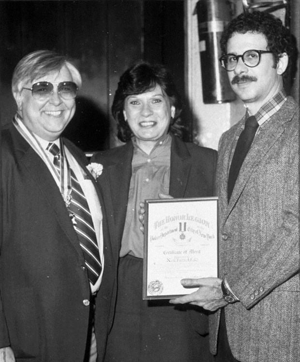 Detective William Abromaitis, far left, gives a merit award to Neal Hirschfeld in 1983. (Joe McKenna / New York Daily News)