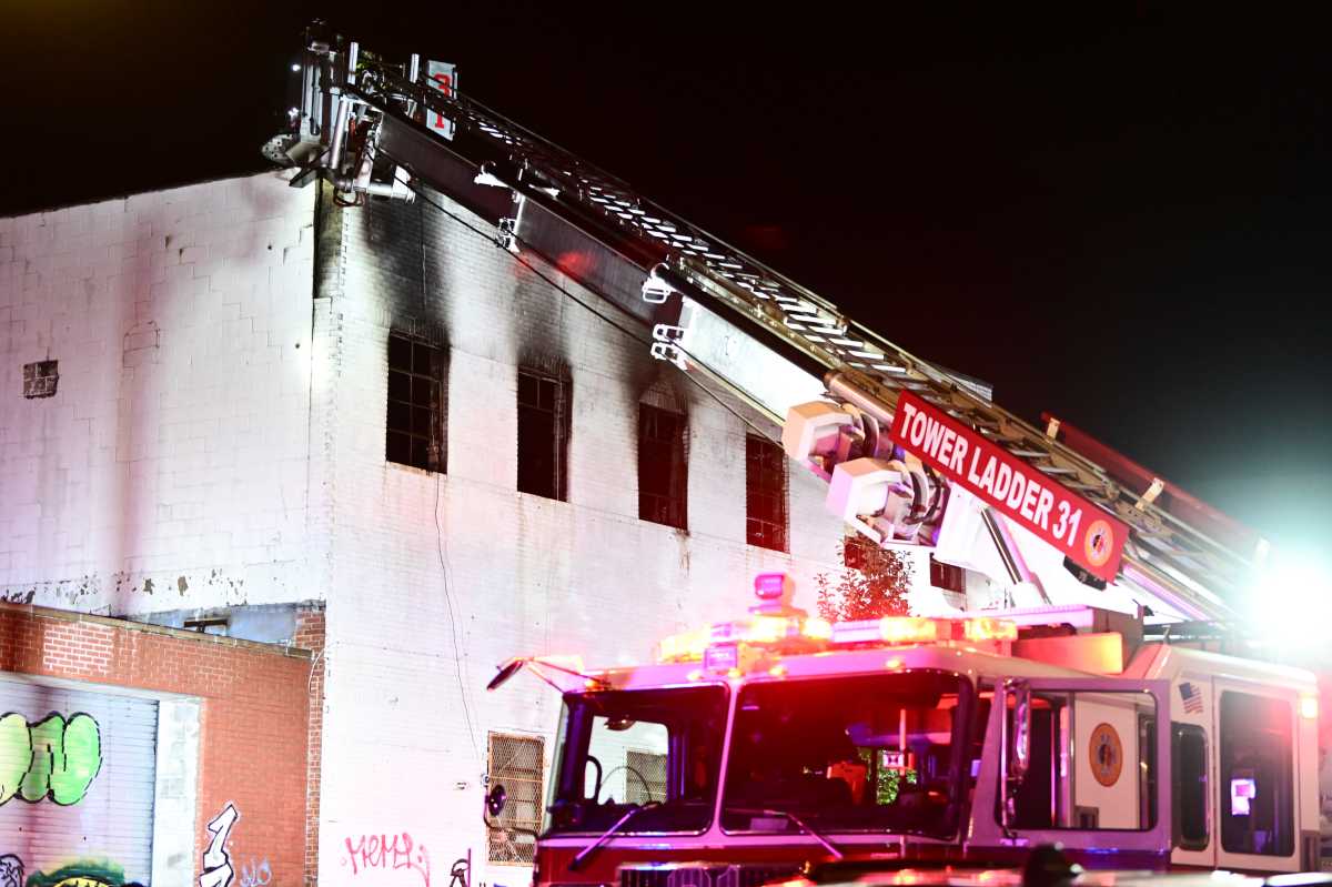 Firefighers arrived to smoke and flames showing from the second floor of a two story commercial bullding at 1717 West Farms Road on Thursday morning.