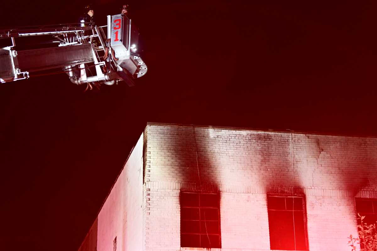 Firefighers arrived to smoke and flames showing from the second floor of a two story commercial bullding at 1717 West Farms Road on Thursday morning.