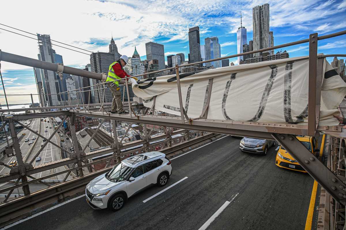 A daredevil climate activist scaled the Brooklyn Bridge on Wednesday afternoon and hung a banner over traffic urging voters to think of nature when they go to the polls next month.