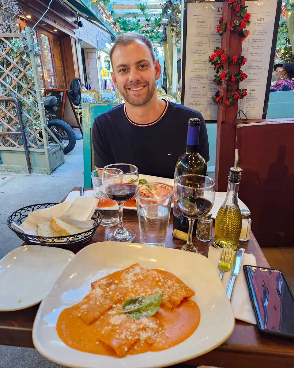 Daniel eats pasta Italian food with wine in New York City, New York