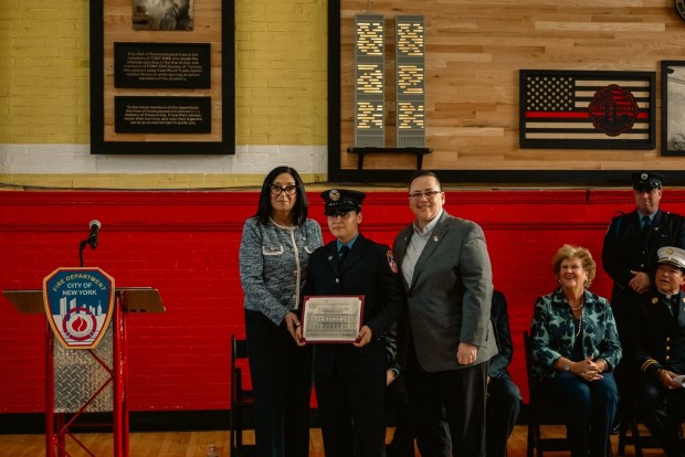 FDNY Commissioner Lillian Bonsignore (far right) is pictured with EMT Haley Soto (center) after Soto was honored with a City Council Citation during the ceremony on Wednesday, Oct. 14, 2026, at the FDNY EMS Academy on Fort Totten in Queens. (FDNY)