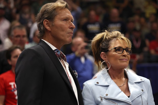 Former Alaska Gov. Sarah Palin (R) stands with her boyfriend former-NHL star Ron Duguay during a "Save America" rally at Alaska Airlines Center on July 09, 2022 in Anchorage, Alaska.