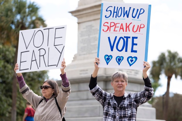 Demonstrators hold signs during a "No Kings" protest at the South Carolina Statehouse on Oct. 17, 2026 in Columbia, South Carolina. (Photo by Sean Rayford/Getty Images)