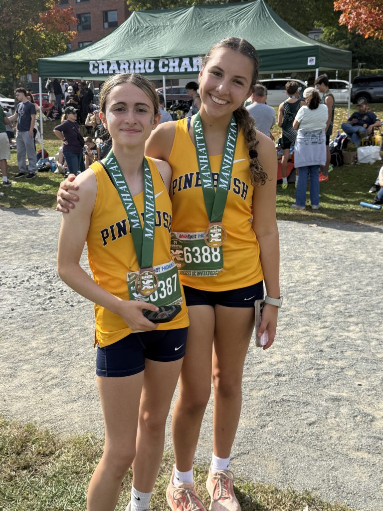two cross country players standing for picture