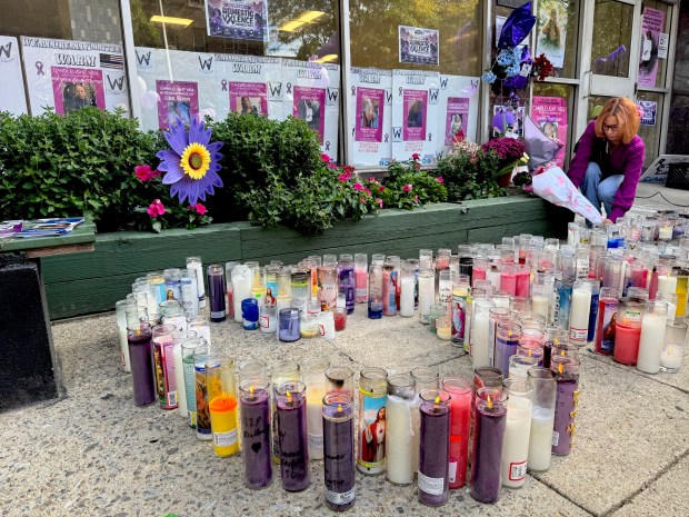 People bring flowers and candles to a memorial for Nathaly Ramierz outside her apartment building on Olinville Ave. in the Bronx on Saturday, Oct. 10, 2026. (Rebecca White / New York Daily News)