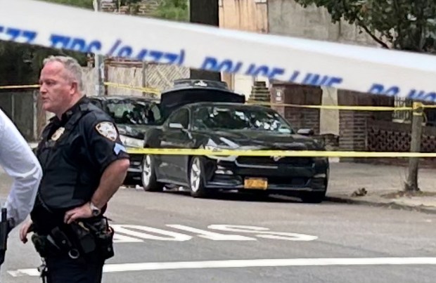 Police investigate after an off-duty NYPD detective was stabbed and wounded during an attempted robbery near his car parked black Mustang (trunk open) at E. 208th St. and Stueben Ave. in the Bronx on Friday, Oct. 2, 2026. (Kerry Burke / New York Daily News)