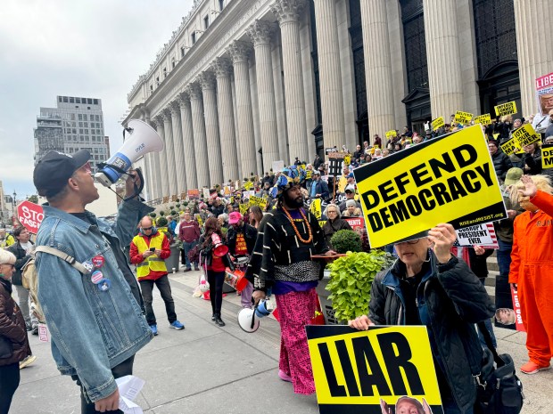 Demonstrators are pictured outside Moynihan Station at 8th Ave. and W. 33rd St. in Manhattan during a Rise and Resist rally Saturday, Oct. 17, 2026. (Rebecca White / New York Daily News)