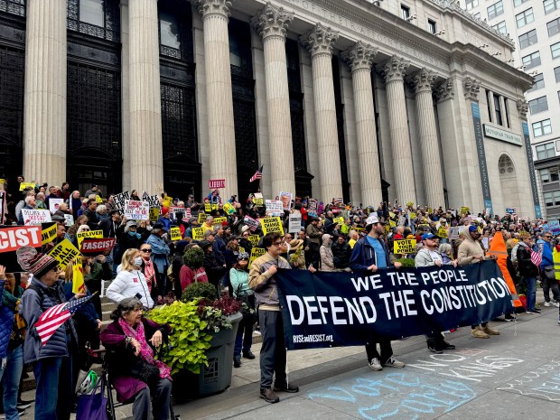 Demonstrators are pictured outside Moynihan Station at 8th Ave. and W. 33rd St. in Manhattan during a Rise and Resist rally Saturday, Oct. 17, 2026. (Rebecca White / New York Daily News)