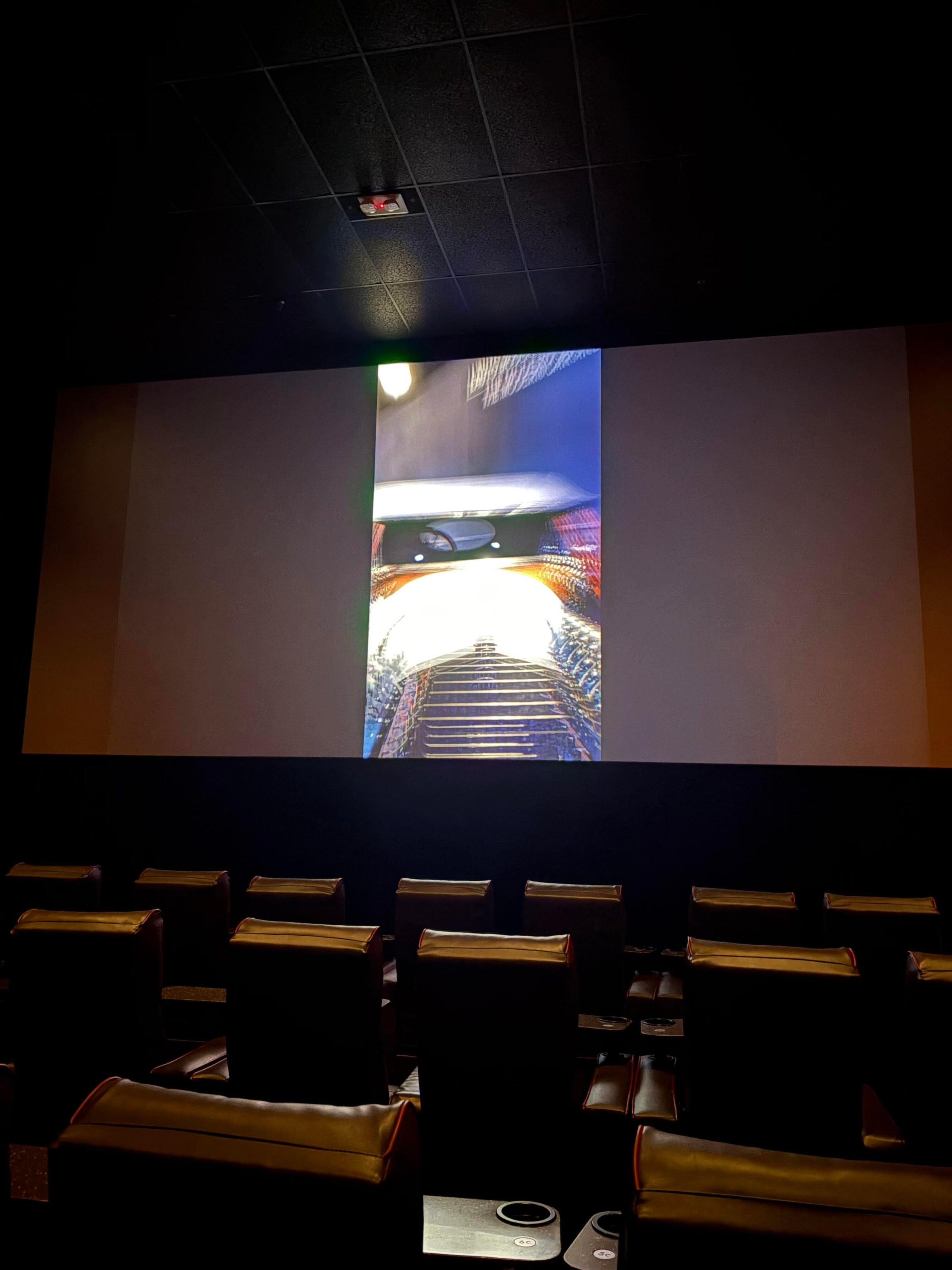 A photo of a vertical microdrama being projected on a movie theater screen.