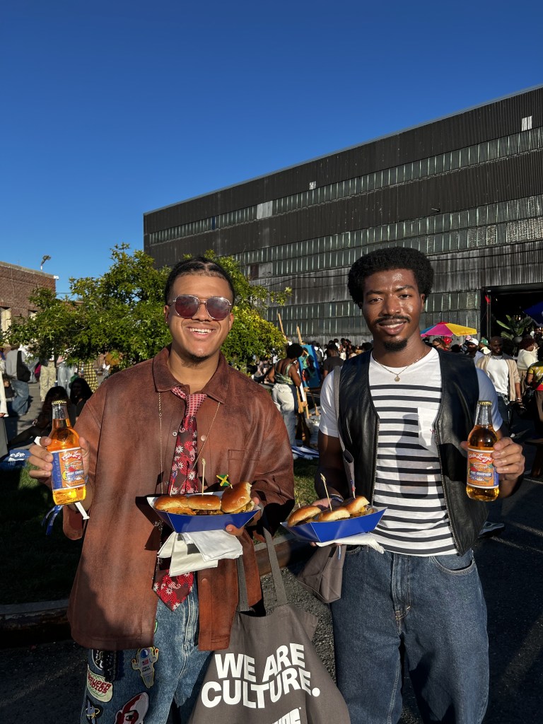 CultureCon attendees enjoy food and drinks outside at the Brooklyn Navy Yard during CultureCon 2026. Photo by Catherine Roth / The Haitian Times
