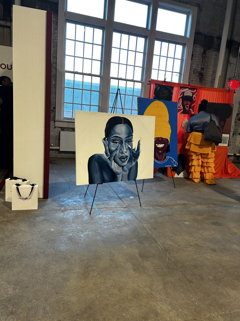 Participating artists' artwork is displayed inside CultureCon 2026 at the Brooklyn Navy Yard in Brooklyn, New York. Photo by Catherine Roth / The Haitian Times

