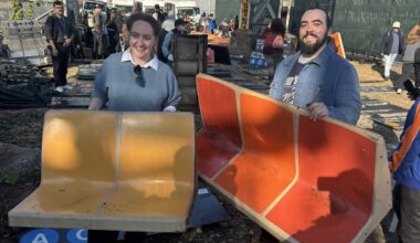 There are subway station signs from across town, plus the iconic yellow and orange seats that are being phased out from the R46 subway cars. (Spectrum News NY1/Roger Clark)