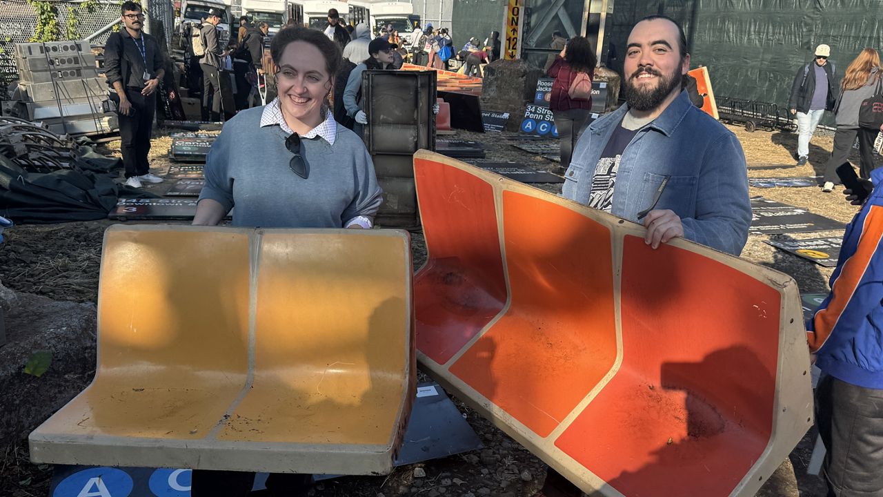 There are subway station signs from across town, plus the iconic yellow and orange seats that are being phased out from the R46 subway cars. (Spectrum News NY1/Roger Clark)