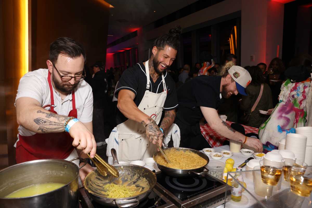 (C) Chef Robbie Felice prepares dishes at Asian Bites & Karaoke Nights hosted by Jet Tila presented by Sake ONO part of the United Airlines Series during the Food Network New York City Wine & Food Festival presented by Invesco QQQ at ASPIRE at One World Observatory on October 18, 2024 in New York City. 