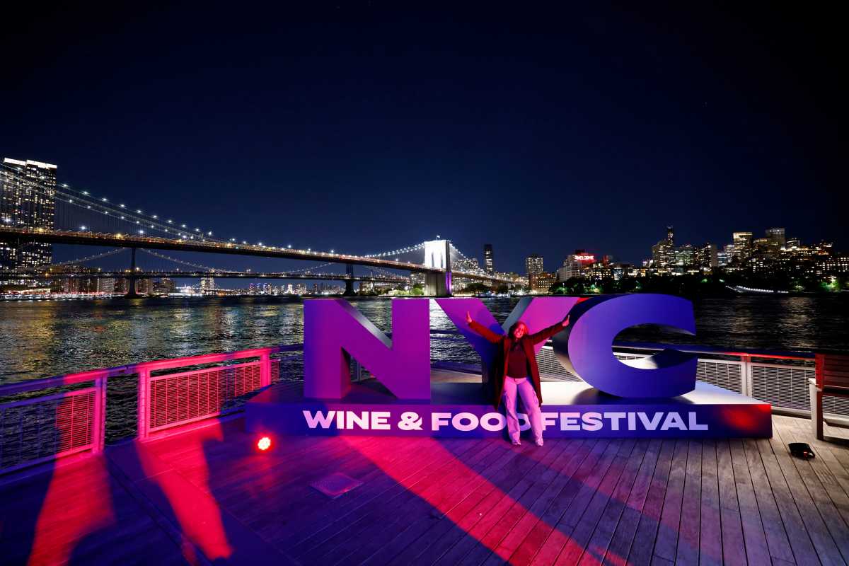 Attendees pose for a photo at the Asian Night Market hosted by Padma Lakshmi and Jean-Georges Vongerichten during the Food Network New York City Wine & Food Festival presented by Invesco QQQ on October 16, 2025 in New York City.  (Photo by Jeff Schear/Getty Images for NYCWFF)