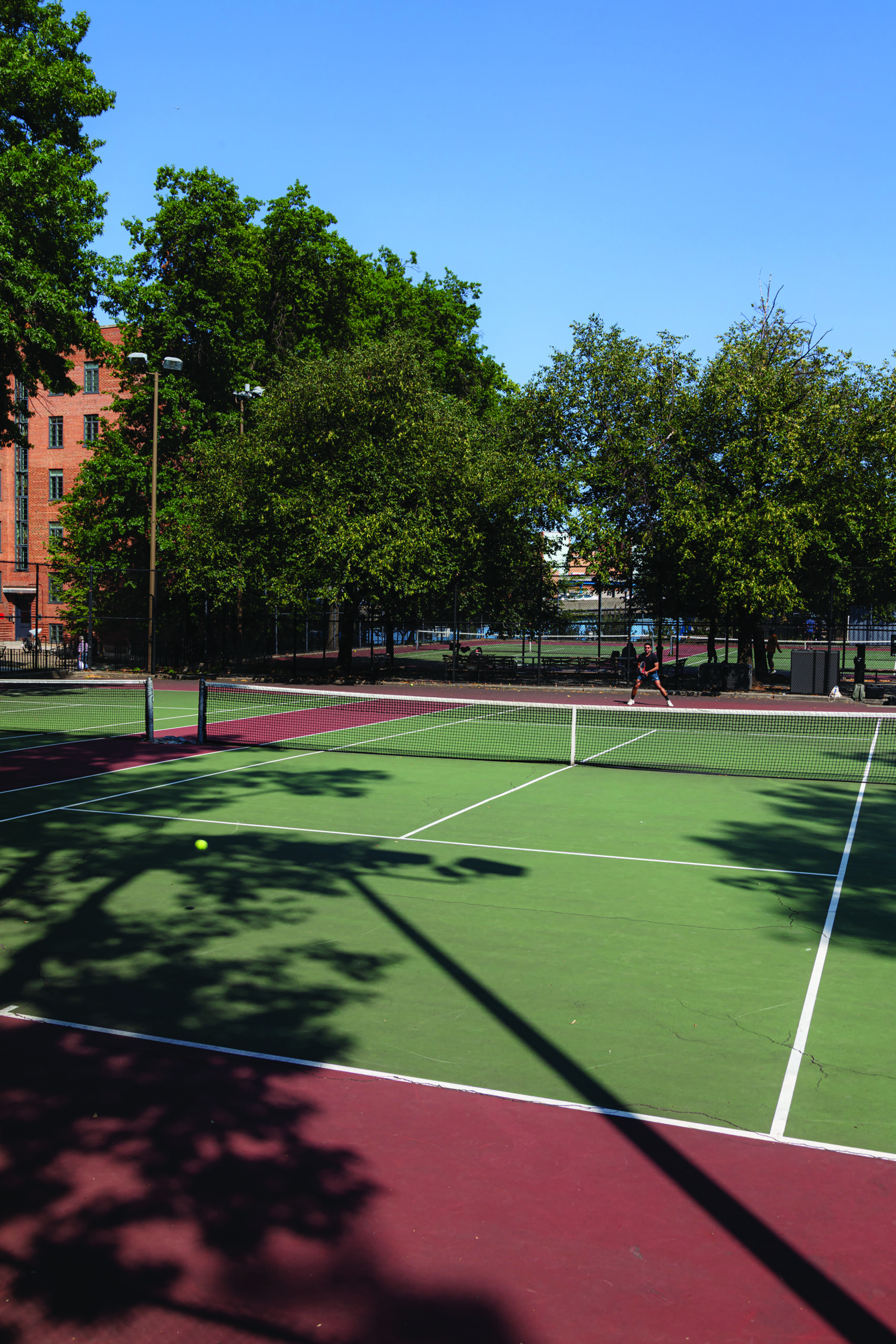 Players on a New York public park pickup tennis court