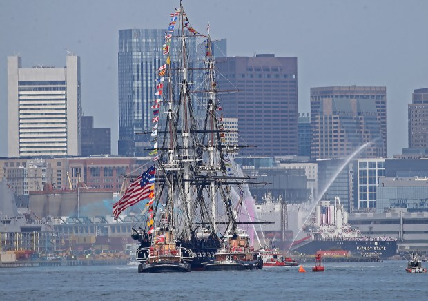 The USS Constitution is towed past fans on Castle island as more than 60 tall ships participate in SailBoston. (Stuart Cahill/Boston Herald)