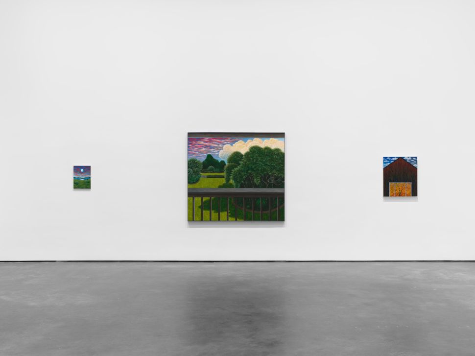 A gallery wall displays three landscape paintings of varying sizes, including a central work depicting trees and a garden beneath a cloud-filled evening sky.