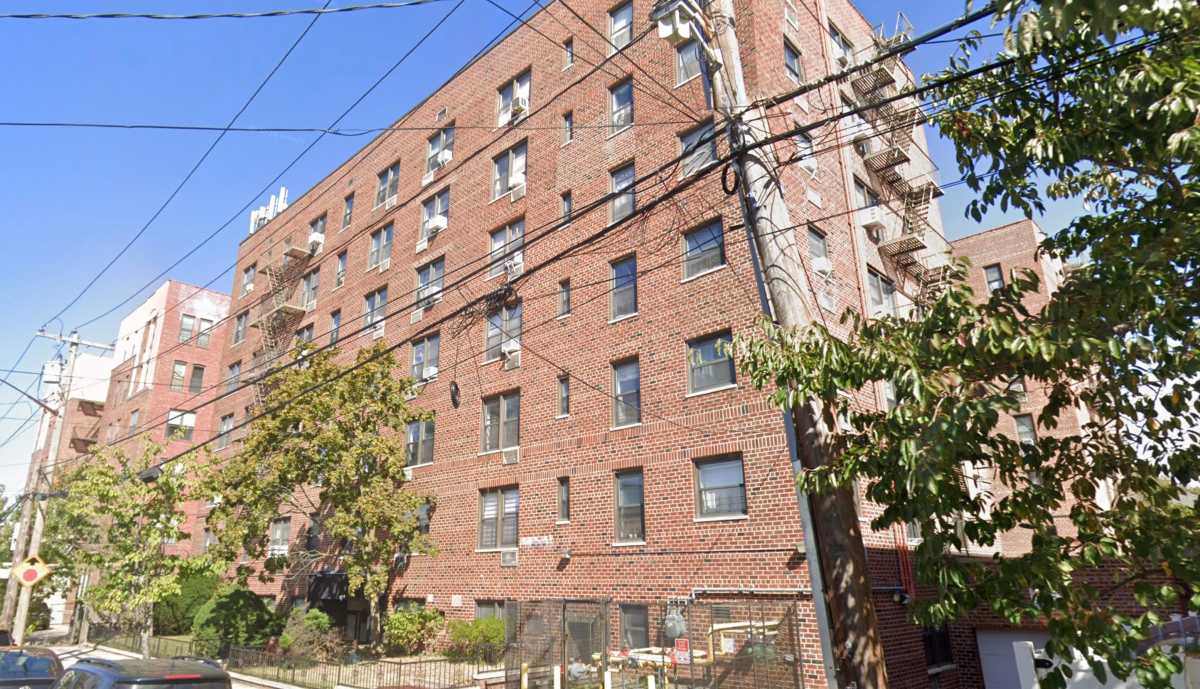 Queens apartment building from which blood-covered man leaped after stabbing woman dead