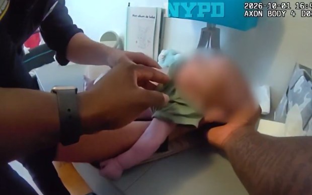 Body cam footage shows police rushing into an apartment within the 114th Precinct around 4:41 p.m. on Oct. 1, when they begin taking turns performing chest compressions on the lifeless infant. (NYPD)
