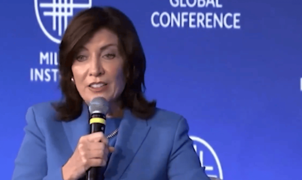 Kathy Hochul speaking into a microphone at the Milken Institute Global Conference.