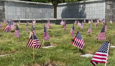 small flags at burial vault