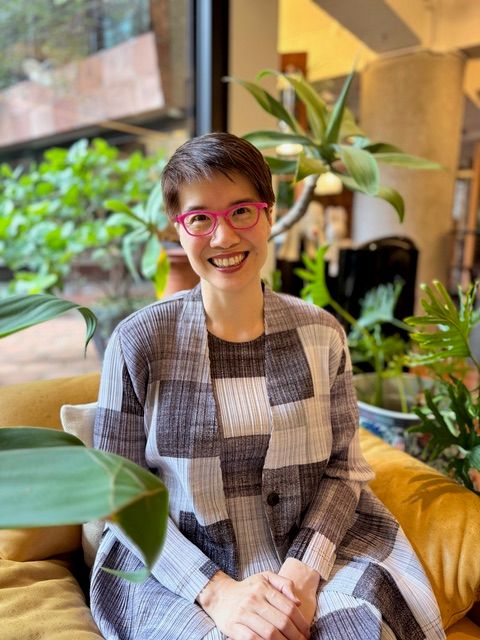 Image may contain Face Happy Head Person Smile Dimples Teen Clothing Sleeve Accessories Glasses and Sitting